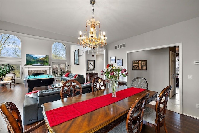 58 Ingram Dr, Troy, MI 48098 - dining area with a chandelier, a fireplace, and hardwood / wood-style flooring