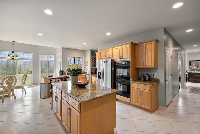 58 Ingram Dr, Troy, MI 48098 - kitchen with stainless steel fridge with ice dispenser, a center island, stone countertops, recessed lighting, and plenty of natural light
