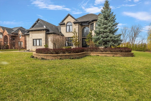58 Ingram Dr, Troy, MI 48098 - french provincial home with a front yard and brick siding