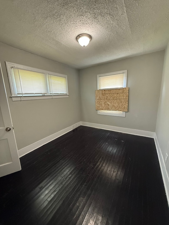 15904 Muirland St, Detroit, MI 48238 - spare room featuring dark wood-style flooring, a textured ceiling, and baseboards
