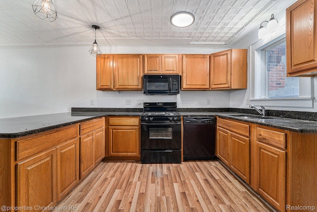 8820 Joseph Campau St Unit 2, Hamtramck, MI 48212 - kitchen featuring black appliances, a peninsula, light wood-style flooring, a sink, and brown cabinetry