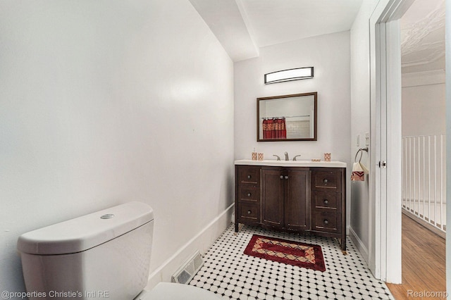 8820 Joseph Campau St Unit 2, Hamtramck, MI 48212 - bathroom with toilet, vanity, and baseboards
