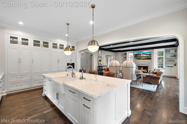 1475 Tottenham Rd, Bloomfield Hills, MI 48301 - kitchen featuring a sink, arched walkways, a warm lit fireplace, crown molding, and open floor plan