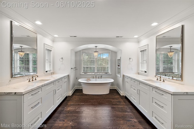 1475 Tottenham Rd, Bloomfield Hills, MI 48301 - bathroom featuring crown molding, two vanities, wood finished floors, a freestanding bath, and baseboards