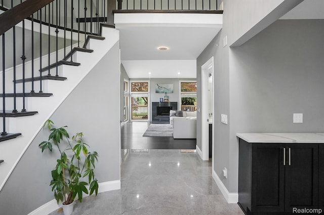 6655 Mountain Dr, Troy, MI 48098 - hall with baseboards, marble tiled floors, stairs, recessed lighting, and a towering ceiling