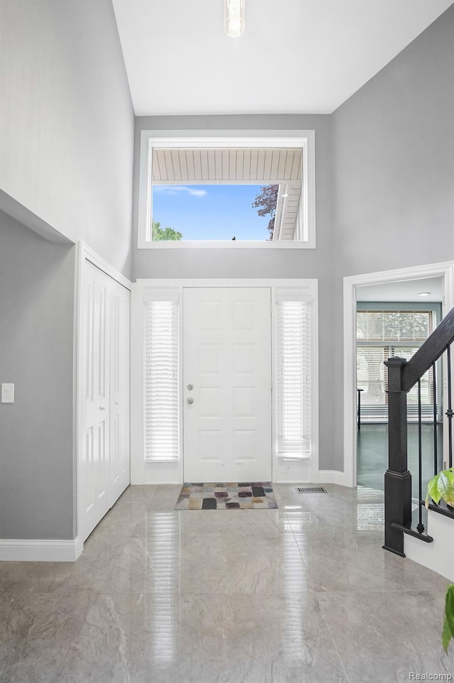 6655 Mountain Dr, Troy, MI 48098 - foyer entrance with a towering ceiling, plenty of natural light, baseboards, and marble tiled floors