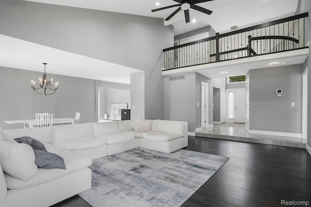 6655 Mountain Dr, Troy, MI 48098 - living room featuring a ceiling fan, a chandelier, baseboards, wood finished floors, and a towering ceiling