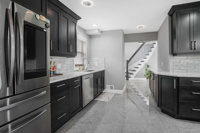 6655 Mountain Dr, Troy, MI 48098 - kitchen featuring appliances with stainless steel finishes, a sink, decorative backsplash, baseboards, and recessed lighting