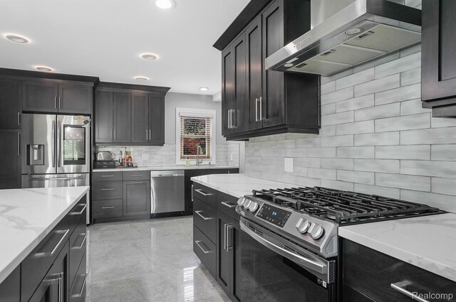 6655 Mountain Dr, Troy, MI 48098 - kitchen featuring wall chimney range hood, stainless steel appliances, backsplash, light stone counters, and a sink