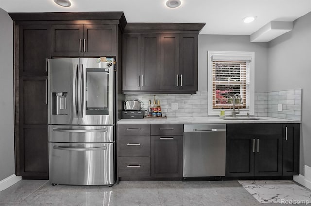 6655 Mountain Dr, Troy, MI 48098 - kitchen featuring stainless steel appliances, a sink, decorative backsplash, light countertops, and baseboards