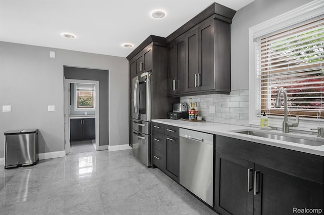 6655 Mountain Dr, Troy, MI 48098 - kitchen featuring stainless steel appliances, a sink, backsplash, light countertops, and baseboards