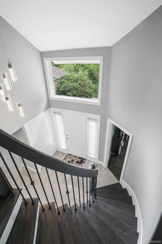 6655 Mountain Dr, Troy, MI 48098 - stairs featuring a towering ceiling and baseboards