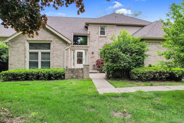 6655 Mountain Dr, Troy, MI 48098 - view of front of home with brick siding, roof with shingles, and a front yard