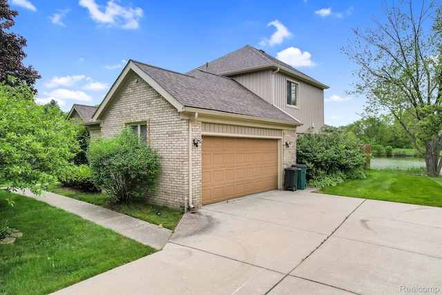 6655 Mountain Dr, Troy, MI 48098 - view of side of home with brick siding, a shingled roof, a lawn, a garage, and driveway