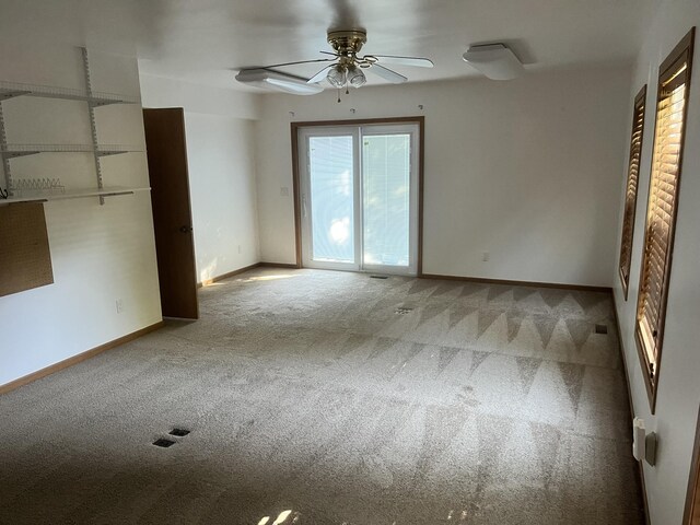 3048 Vineland Ave, Burton, MI 48519 - spare room featuring carpet flooring, ceiling fan, and baseboards