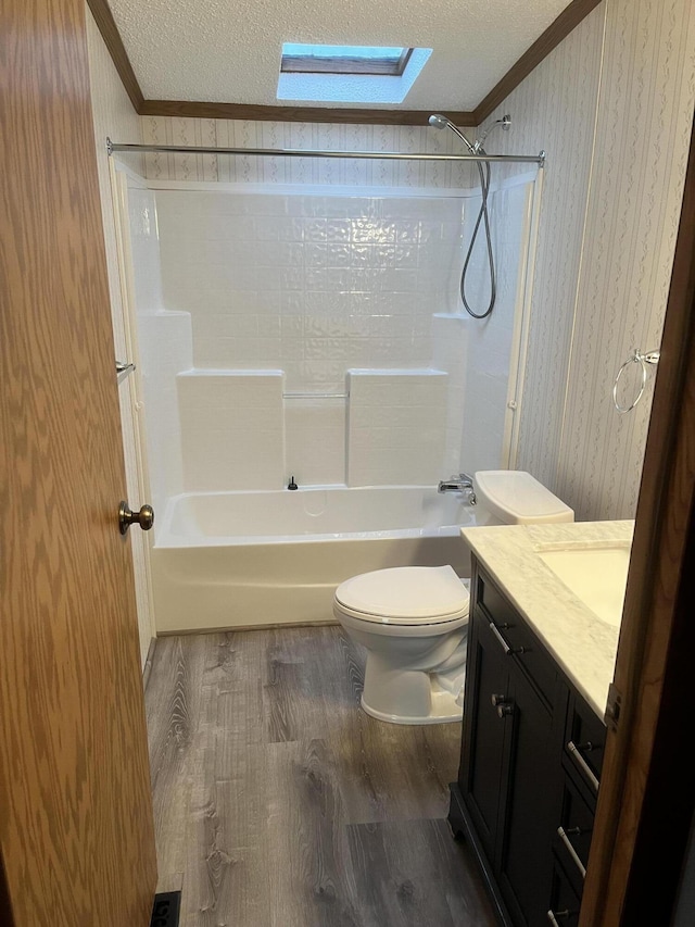3048 Vineland Ave, Burton, MI 48519 - bathroom featuring ornamental molding, wallpapered walls, wood finished floors, a skylight, and toilet