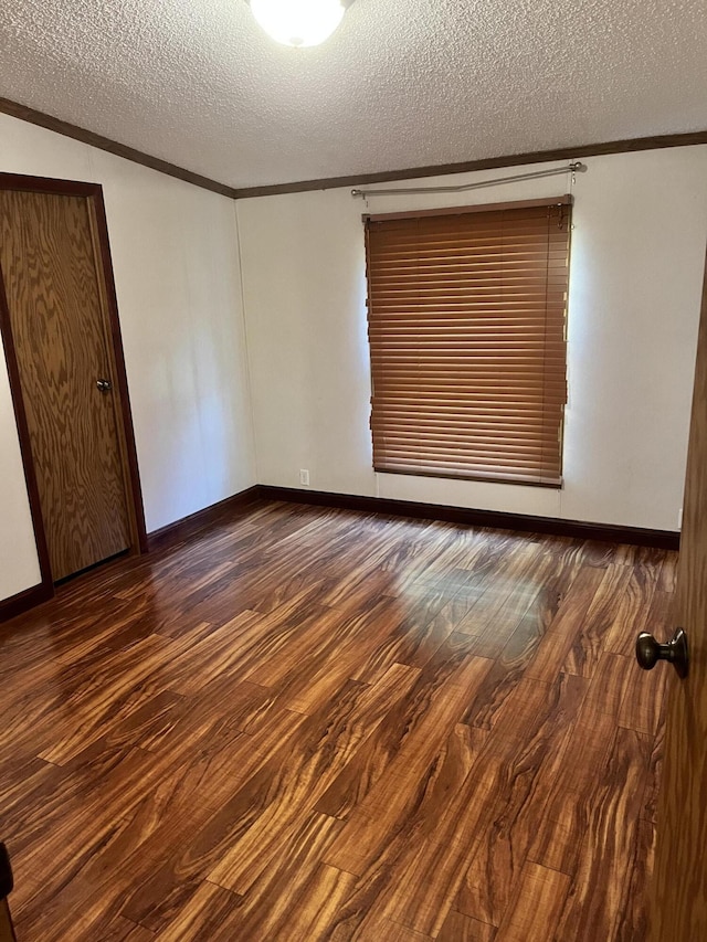 3048 Vineland Ave, Burton, MI 48519 - spare room featuring crown molding, a textured ceiling, wood finished floors, and baseboards