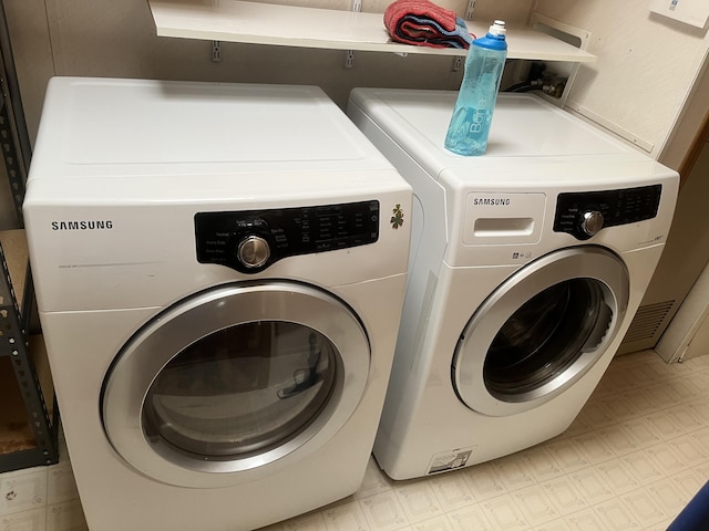 3048 Vineland Ave, Burton, MI 48519 - clothes washing area featuring washing machine and dryer and light floors