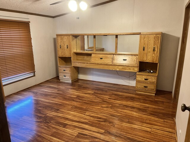 3048 Vineland Ave, Burton, MI 48519 - unfurnished bedroom featuring dark wood-type flooring, a textured ceiling, ceiling fan, and crown molding