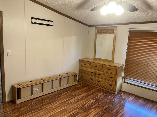 3048 Vineland Ave, Burton, MI 48519 - unfurnished bedroom with ornamental molding, a textured ceiling, dark wood-style flooring, and ceiling fan