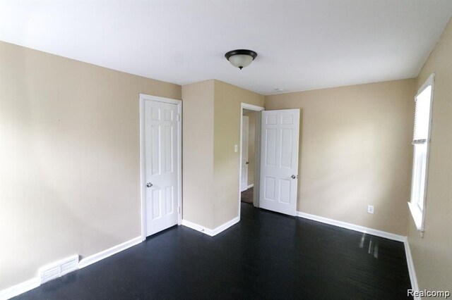 15470 Mapleridge St, Detroit, MI 48205 - unfurnished bedroom featuring baseboards and dark wood-type flooring