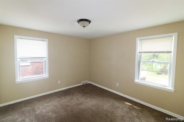 15470 Mapleridge St, Detroit, MI 48205 - empty room with dark colored carpet and baseboards