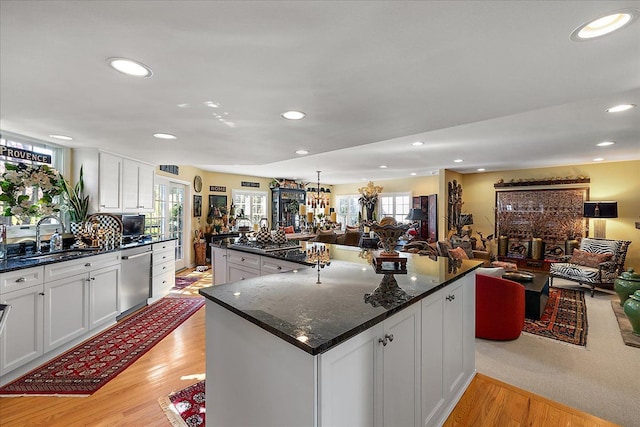 1301 Fairway Dr, Birmingham, MI 48009 - kitchen featuring a sink, stainless steel dishwasher, open floor plan, white cabinetry, and light wood finished floors