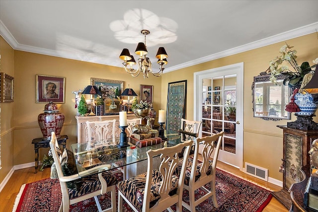 1301 Fairway Dr, Birmingham, MI 48009 - dining space with a chandelier, wood finished floors, ornamental molding, and baseboards
