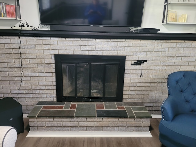 detailed view of wood finished floors and a fireplace