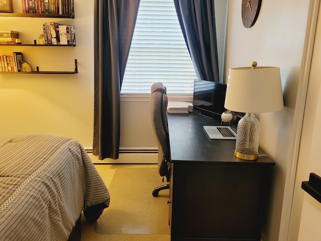 bedroom featuring baseboard heating and a desk