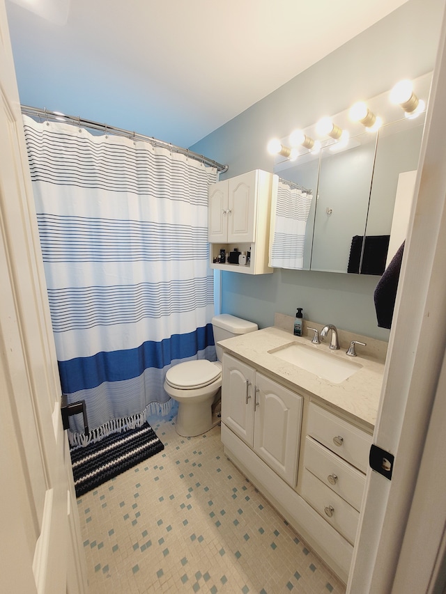 bathroom with toilet, vanity, and a shower with curtain