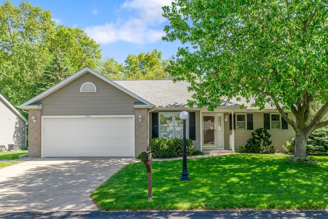 9545 Bonita Ct, Portage, MI 49002 - single story home featuring an attached garage, concrete driveway, a front lawn, brick siding, and a shingled roof