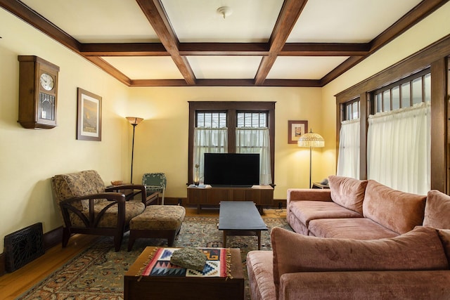 living area featuring coffered ceiling, beamed ceiling, wood finished floors, and baseboards