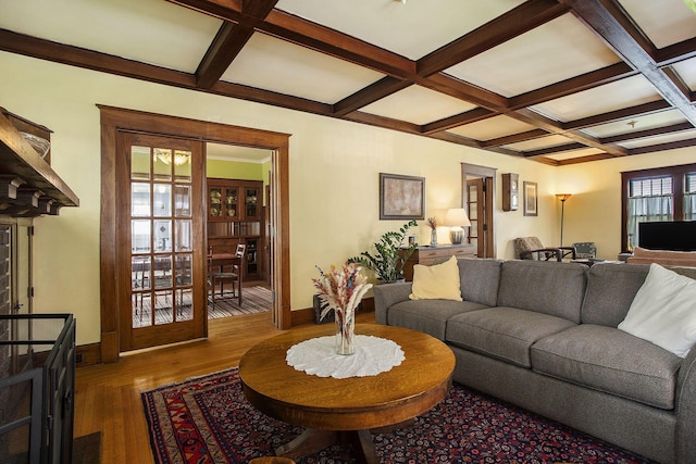 living room with coffered ceiling, beamed ceiling, baseboards, and dark wood-type flooring