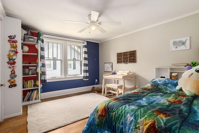 bedroom featuring ornamental molding, wood finished floors, baseboards, and ceiling fan