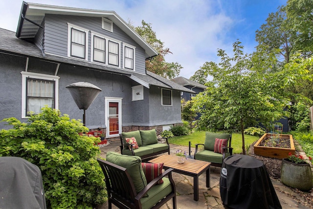 view of patio featuring outdoor lounge area, a vegetable garden, and grilling area