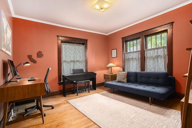 home office with light wood-style floors, crown molding, and baseboards
