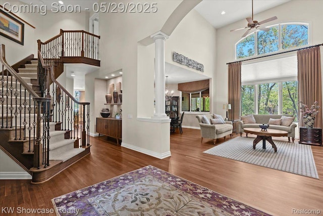 4563 Haverhill, Commerce Twp, MI 48382 - foyer with decorative columns, a towering ceiling, wood finished floors, ceiling fan, and baseboards