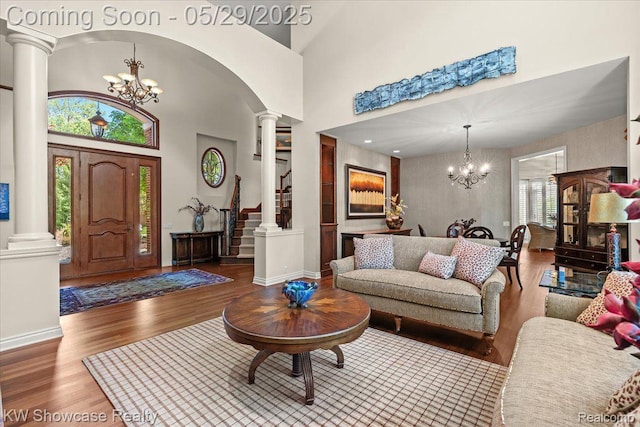 4563 Haverhill, Commerce Twp, MI 48382 - living area with decorative columns, a chandelier, wood finished floors, baseboards, and a high ceiling