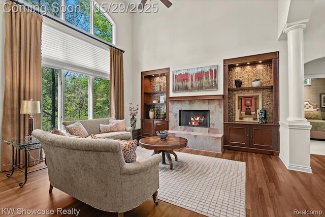4563 Haverhill, Commerce Twp, MI 48382 - living room with ornate columns, a high end fireplace, plenty of natural light, and a towering ceiling