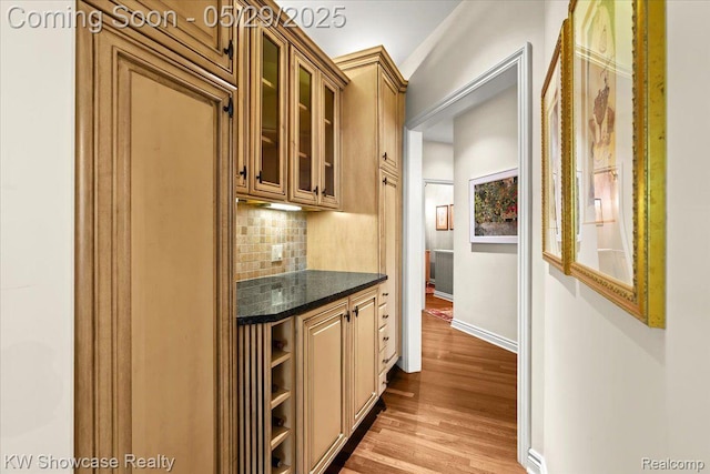 4563 Haverhill, Commerce Twp, MI 48382 - bar featuring decorative backsplash, wood finished floors, and baseboards