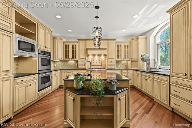 4563 Haverhill, Commerce Twp, MI 48382 - kitchen with cream cabinetry, appliances with stainless steel finishes, open shelves, wood finished floors, and a sink