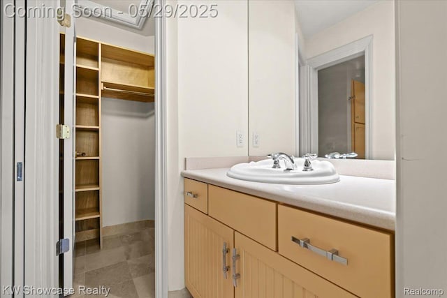 4563 Haverhill, Commerce Twp, MI 48382 - bathroom with vanity, a walk in closet, and baseboards
