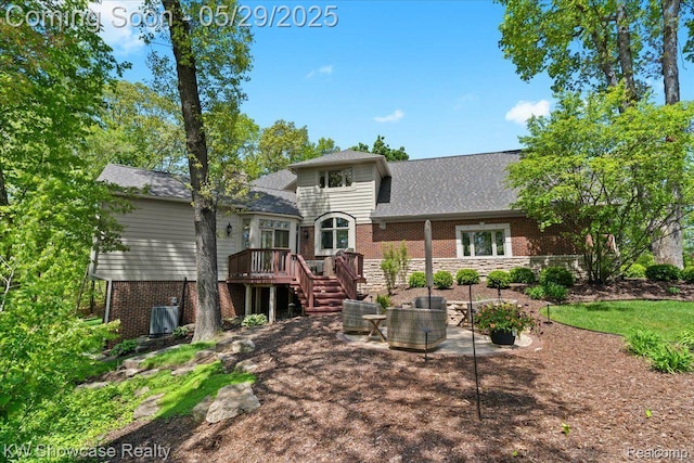 4563 Haverhill, Commerce Twp, MI 48382 - back of property with a deck, brick siding, a patio, a shingled roof, and stairway