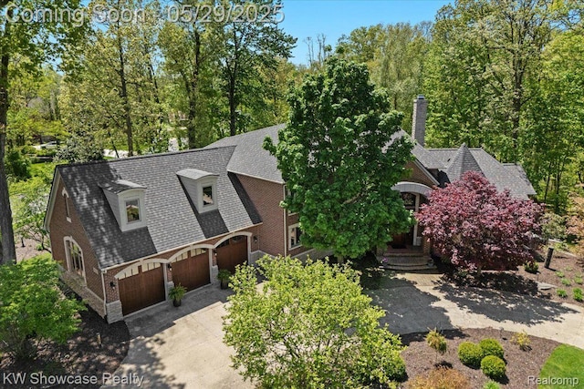 4563 Haverhill, Commerce Twp, MI 48382 - view of front of property featuring concrete driveway, a chimney, and a shingled roof