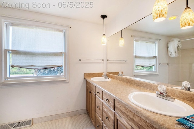 4371 E Cook Rd, Grand Blanc, MI 48439 - full bathroom with double vanity, tile patterned flooring, and baseboards