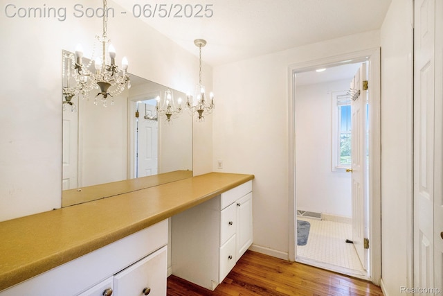 4371 E Cook Rd, Grand Blanc, MI 48439 - bathroom featuring a chandelier, wood finished floors, and vanity