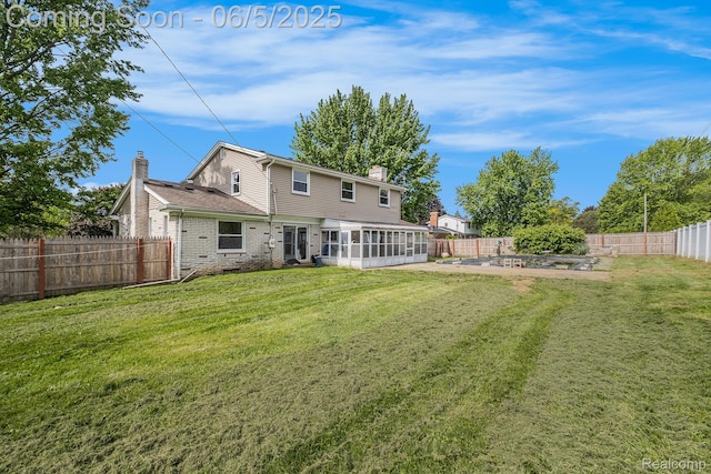4371 E Cook Rd, Grand Blanc, MI 48439 - back of house featuring a chimney, a sunroom, a vegetable garden, and brick siding