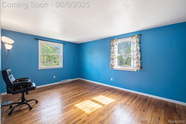 4371 E Cook Rd, Grand Blanc, MI 48439 - unfurnished office featuring wood finished floors and baseboards