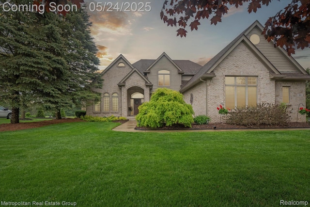 921 Gleneagles, Highland, MI 48357 - view of front facade featuring brick siding and a front yard